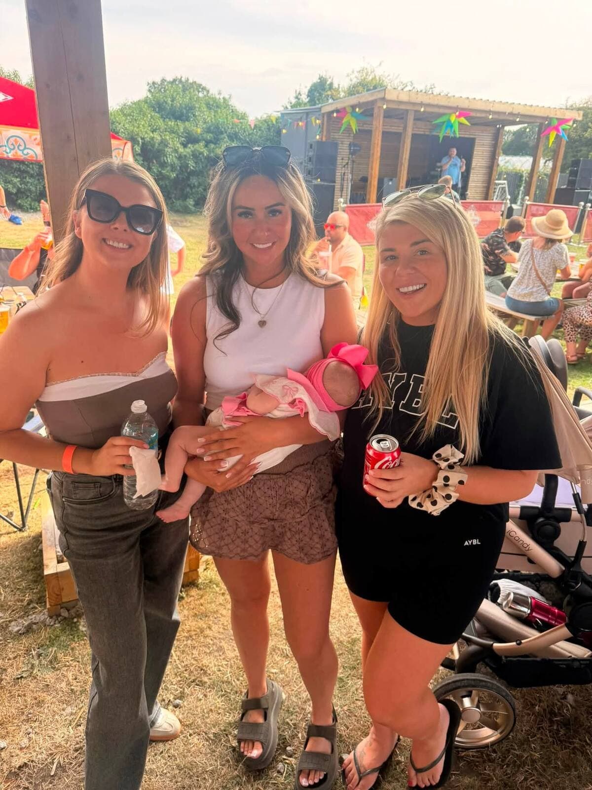 A baby held up in front of the stage at The Comfortable Gill Garden Party