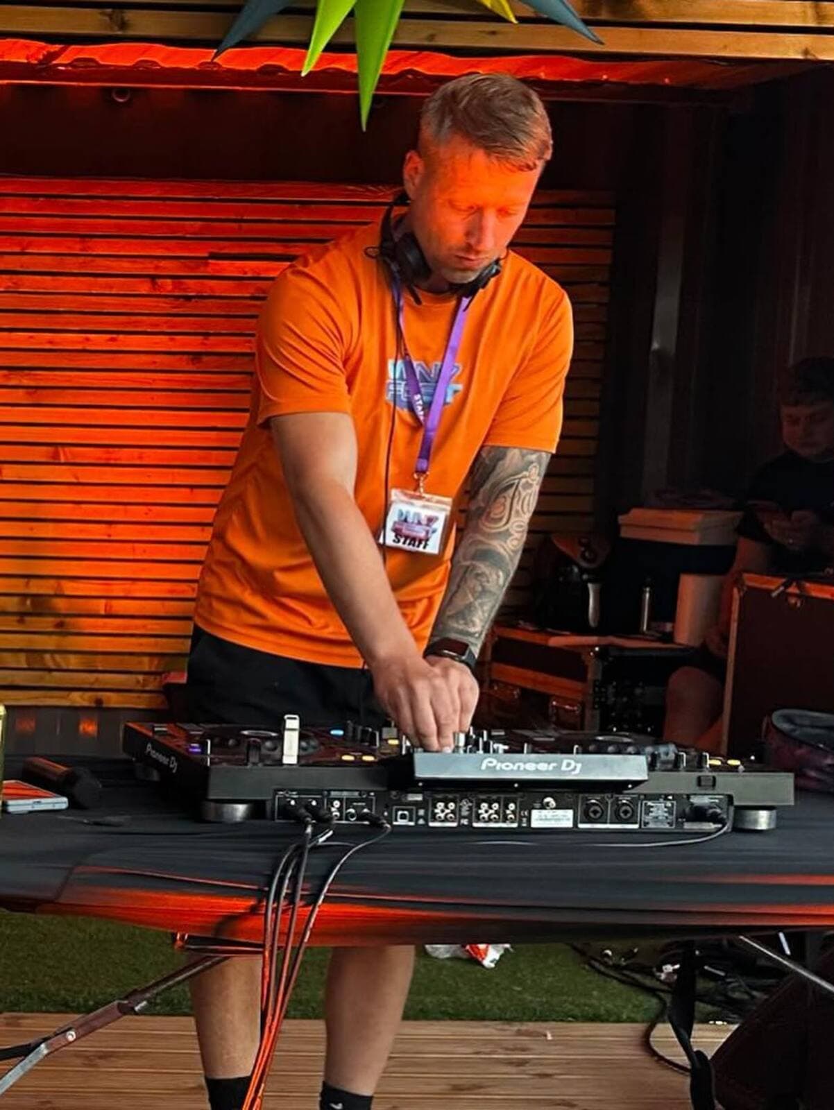 The DJ at the decks in a WN7 FEST shirt at the Garden Party