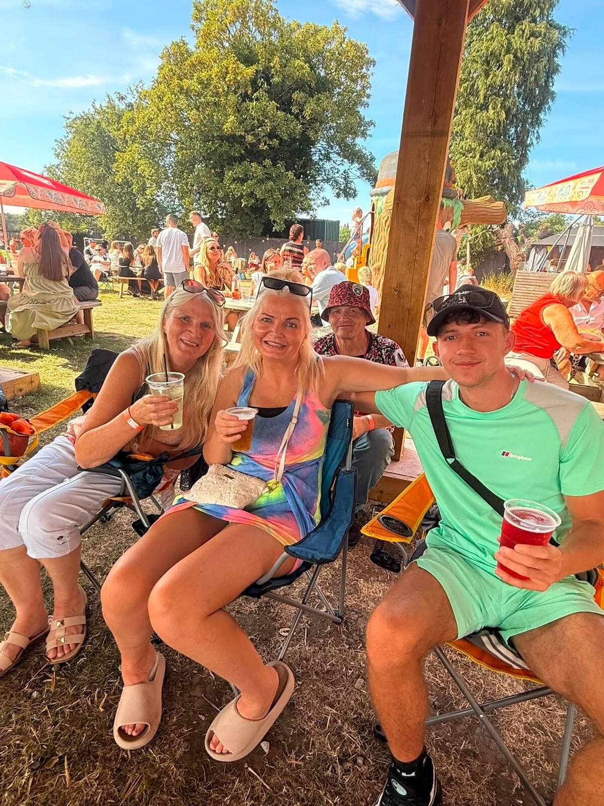 Friends in camping chairs with drinks in the sunshine at the WN7 FEST Garden Party