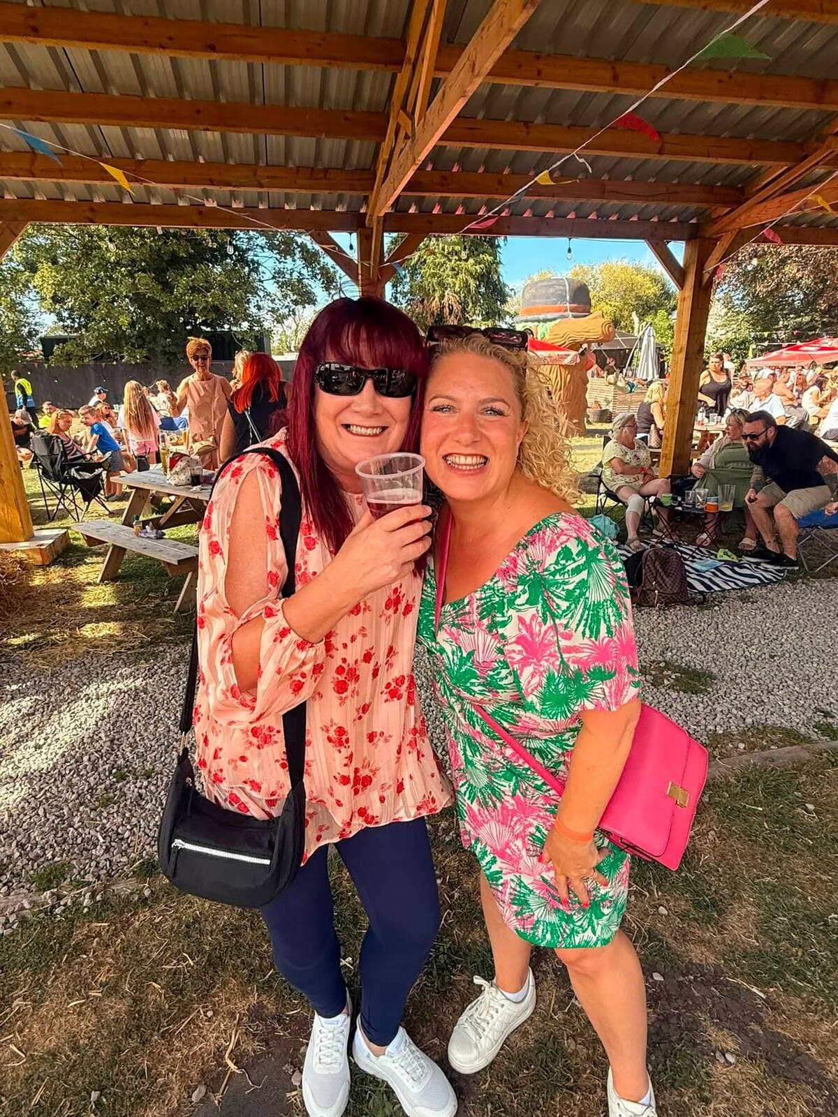 Two friends under the timber pergola at The Comfortable Gill Garden Party