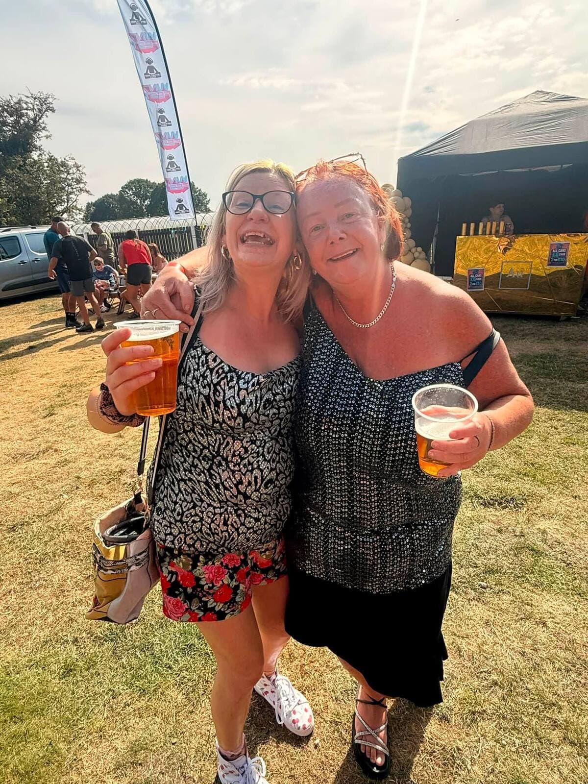 Two friends with pints in the sunshine at the WN7 FEST Garden Party