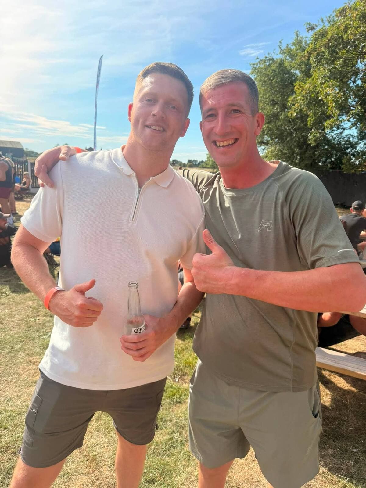 Two friends raising a drink at The Comfortable Gill Garden Party