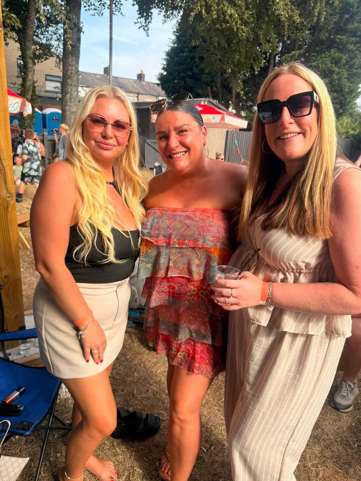 Three friends in the sunshine at The Comfortable Gill Garden Party, Leigh